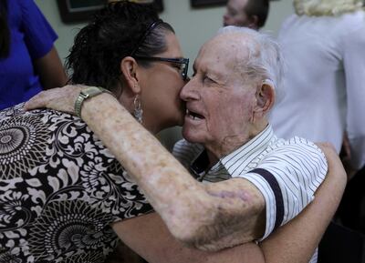 Kathy Short kisses her grandfather, Staff Sgt. Stanley Nance, a World War II Ghost Army veteran, at the office of Rep. Ben McAdams, D-Utah, in West Jordan on Monday, July 1, 2019. The Ghost Army was a unit composed largely of artist that had unusual order