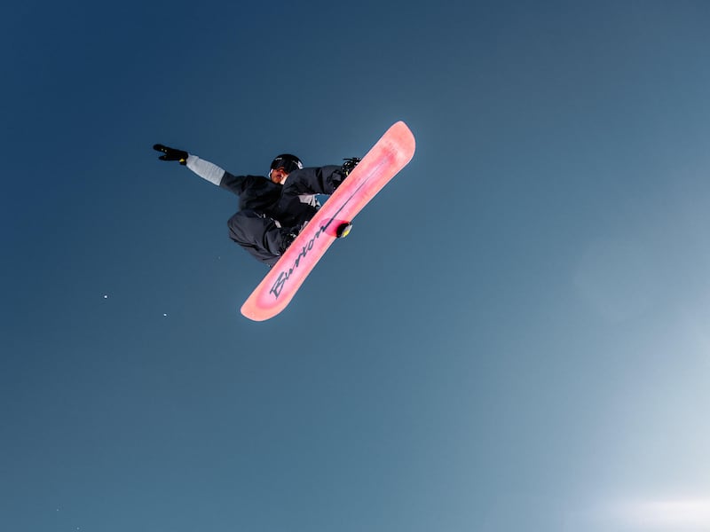 Snowboarder Brian Rice doing a trick at Park City in the new Warren Miller film.