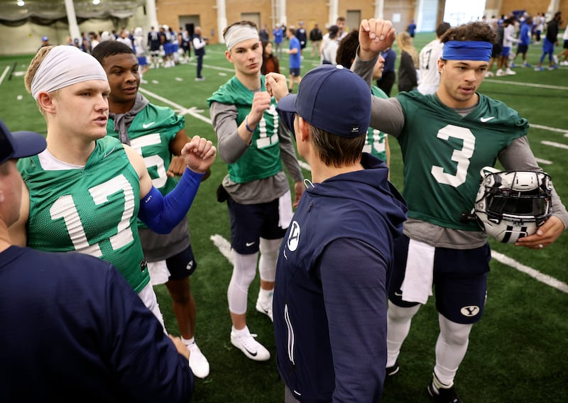 BYU quarterbacks Jacob Conover, Nick Billoups, Cade Fennegan, Sol-Jay Maiava-Peters and Jaren Hall huddle up during practice.