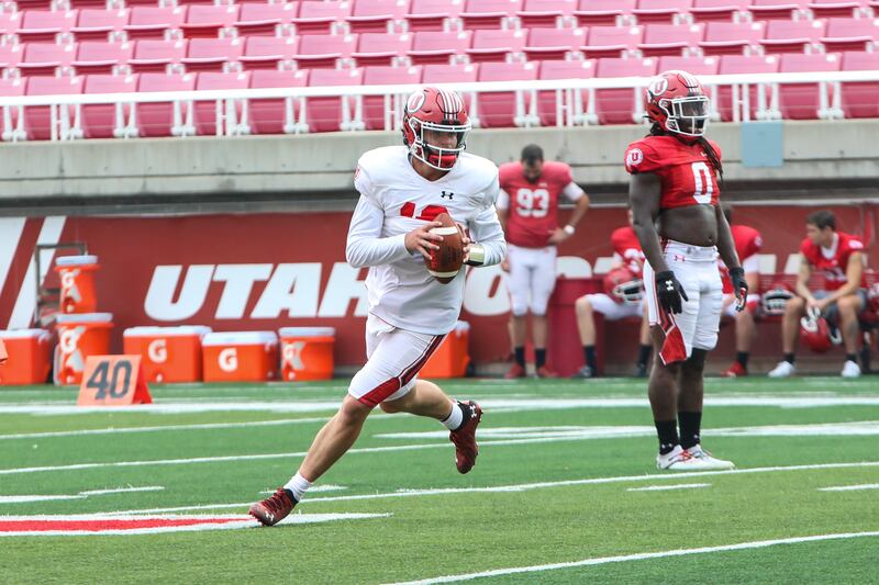 Utah quarterback Charlie Brewer rolls out at Rice-Eccles Stadium in Salt Lake City during fall camp.