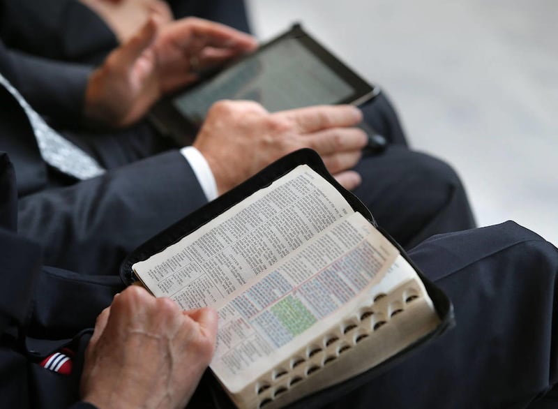 Tradition and electronic bibles at the Public Bible Reading at the Utah State Capitol with many community and religious leaders reading favorite passages from the Bible for National Bible Week. Salt Lake City has been selected by the National Bible Associ