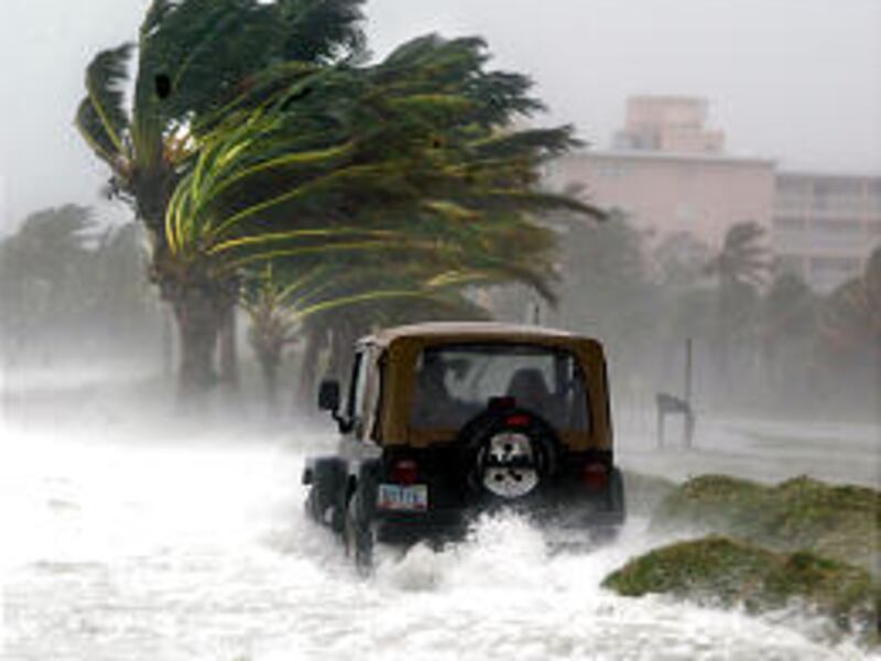 A jeep makes its way down Atlantic Avenue in Key West, Fla., Saturday as Hurricane Dennis barreled toward the Gulf Coast.