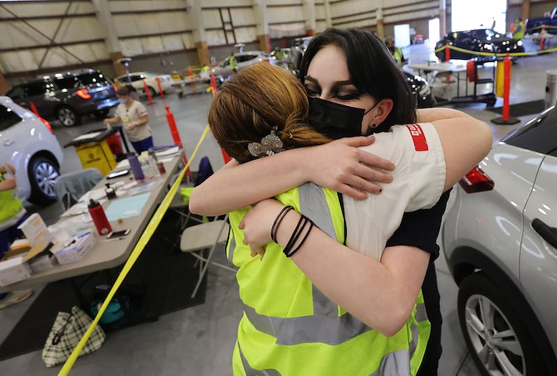 Kristen Hawes, left, hugs her daughter, Amberly Hawes, 16, after giving her a COVID-19 vaccine at in Farmington on Thursday.