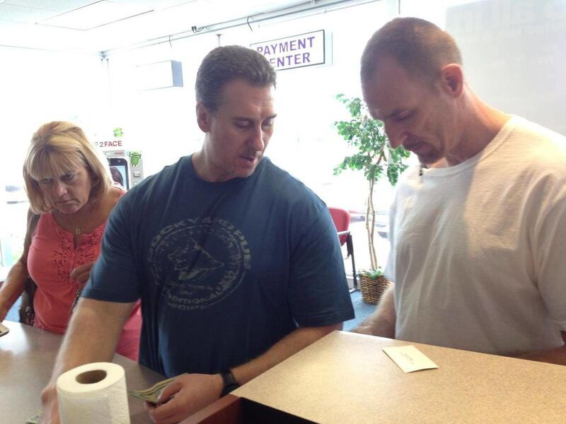 Janet Hirth takes her twin nephews, Thomas and Taymond Highers, both 46, to the Metro PCS store to buy new cellphones in Roseville, Mich., after being released from prison on Tuesday, Aug. 14, 2012.