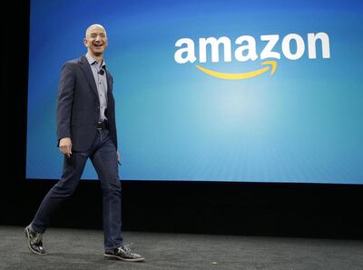 In this June 18, 2014 file photo, Amazon CEO Jeff Bezos walks on stage for the launch of the new Amazon Fire Phone, in Seattle. Amazon launched on the web twenty years ago on July 16, 1995.