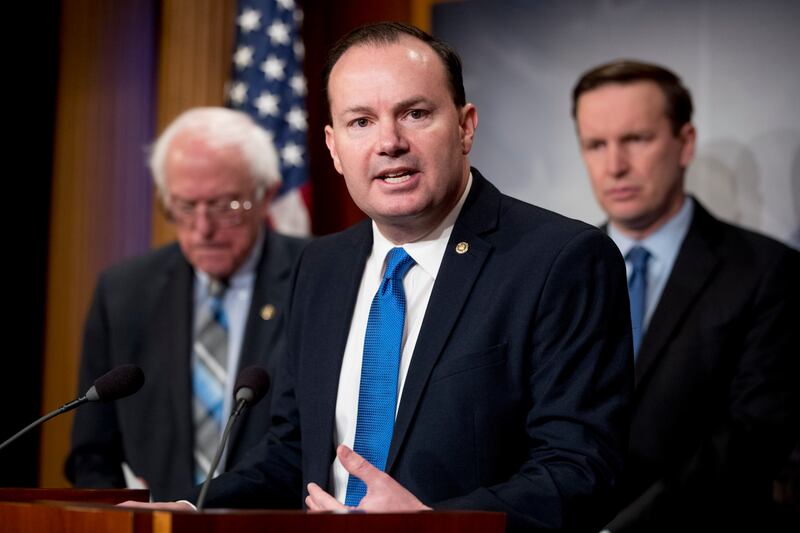 Sen. Mike Lee, R-Utah, accompanied by Sen. Bernie Sanders, I-Vt., left, and Sen. Chris Murphy, D-Conn., right, speaks at a news conference on Capitol Hill in Washington, Wednesday, Jan. 30, 2019, on a reintroduction of a resolution to end U.S. support for the Saudi-led war in Yemen. (AP Photo/Andrew Harnik)