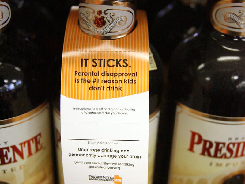 FILE - A peel-and-stick label is attached to liquor bottles at the liquor store in Sugar House on May 8, 2008 as a reminder that liquor in the home is not appropriate for consumption by those under 21. A campaign called Parents Empowered that is being lau