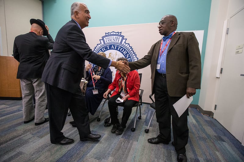 District Attorney Sim, left, shakes hands with Rev. France A. Davis after the press conference about the formation of a Conviction Integrity Unit at Salt Lake County District Attorney’s Office in Salt Lake City on Monday, Oct. 8, 2018.