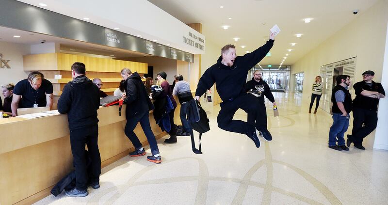 After getting his tickets, John Butterfield jumps into the air for the others waiting in line at The George S. and Dolores Doré Eccles Theater in Salt Lake City for Hamilton tickets to go on sale on Friday, Feb. 9, 2018.