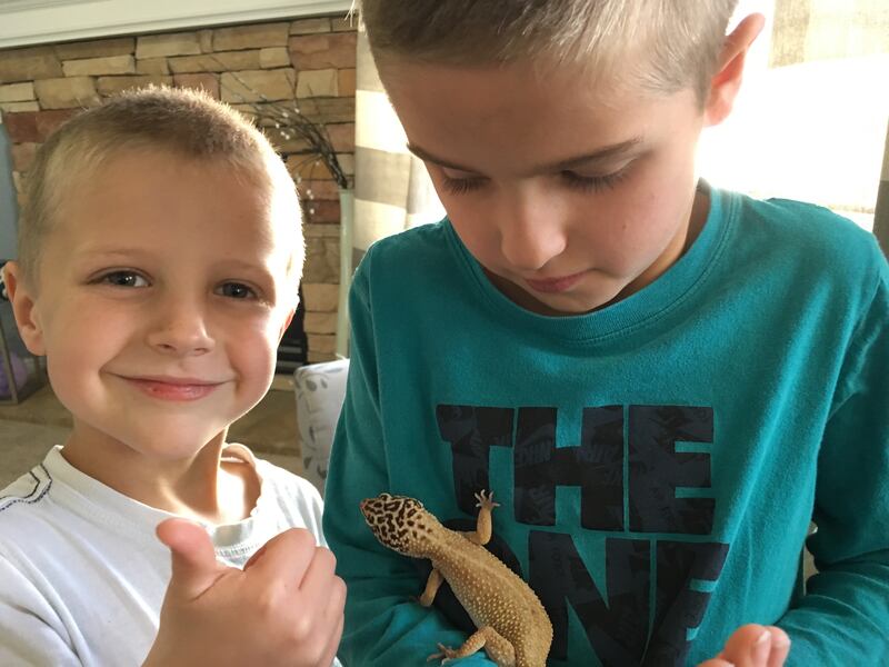 Grey and Jace Packer with their lizard, Tangerine, who they've renamed Lazarus.