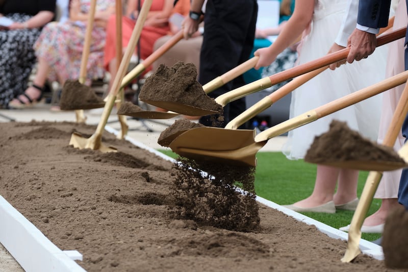 Shovelfuls of dirt commemorate breaking ground for the Wichita Kansas Temple .