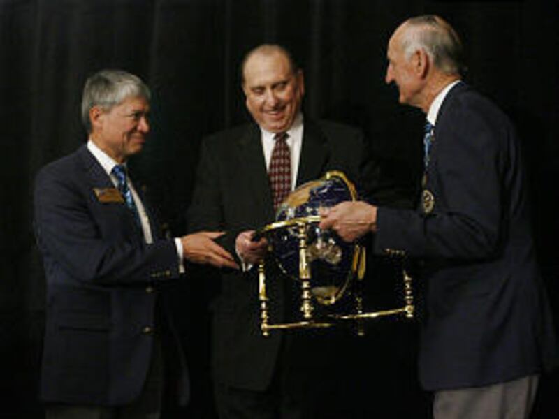 Thomas S. Monson receives the Special Worldwide Humanitarian award from Rotary leaders Eugene Banks, left, and W.B. Boyd Saturday.