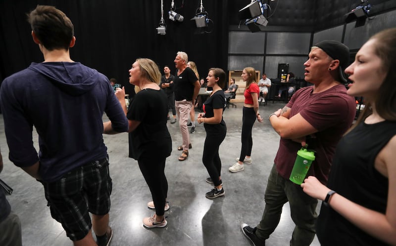 Air Supply’s Graham Russell, center, sings with the cast during rehearsal for the musical “A Wall Apart” at the TV studio on the Salt Lake Community College campus in Salt Lake City on Tuesday, July 30, 2019.