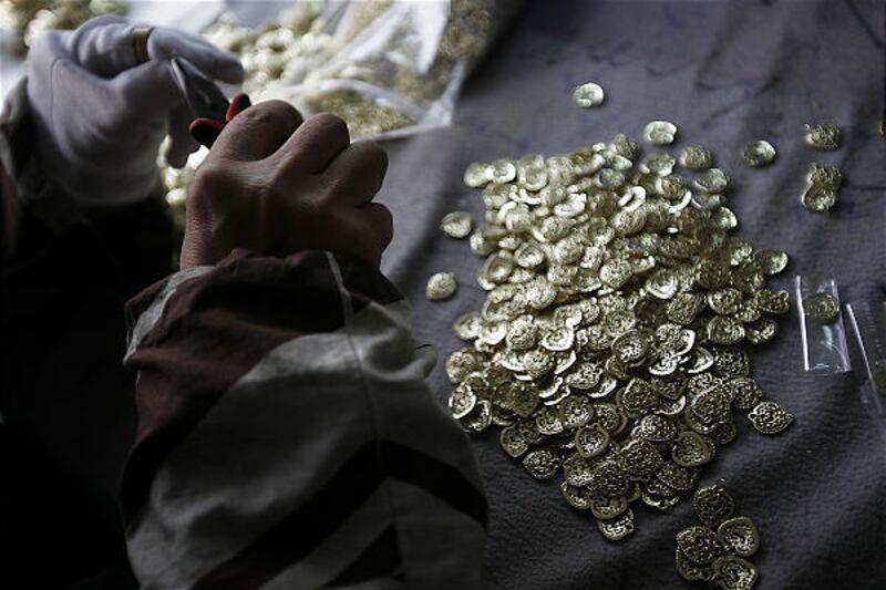 A worker assembles jewelry at a small factory Tuesday in Yiwu, China. Cadmium is used in a lot of Chinese jewelry.
