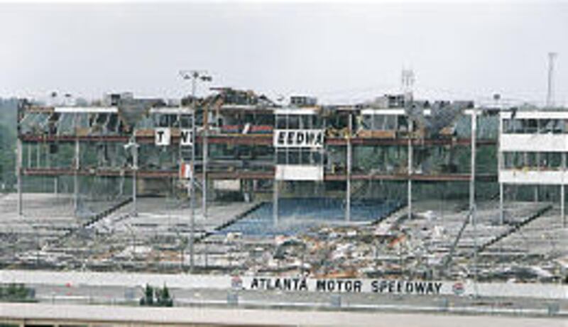 Wind-shredded grandstands and boxes circle a portion of the track at Atlanta Motor Speedway on Thursday after a tornado struck.
