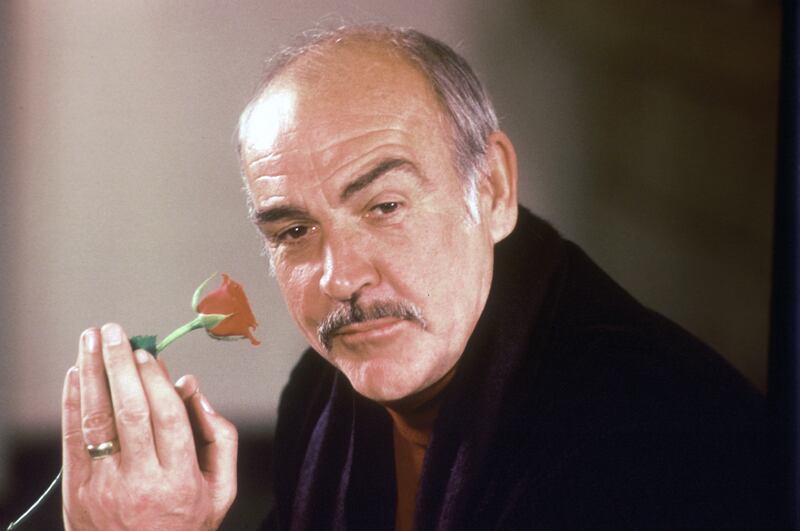 In this Jan. 23, 1987 file photo, actor Sean Connery holds a rose in his hand as he talks about his new movie “The Name of the Rose” at a news conference in London. Scottish actor Sean Connery, considered by many to have been the best James Bond, has died aged 90, according to an announcement from his family.