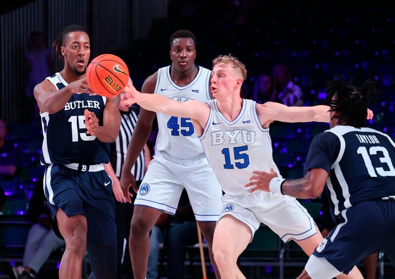 Butler’s Manny Bates, left, passes the ball as BYU’s Richie Saunders reaches for it during a game in the Battle 4 Atlantis at Paradise Island, Bahamas, Thursday, Nov. 24, 2022.