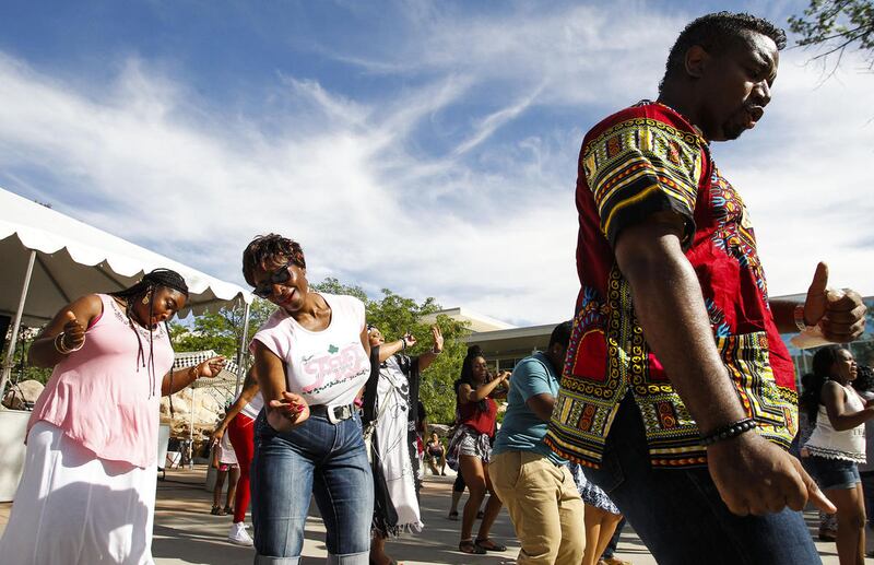 Right to left: Wazir Jefferson, Shaun Graves-Robertson and Kimberley Butler dance to music at the 27th annual Juneteenth Freedom & Heritage Festival at Weber State University Bell Tower in Ogden, Utah, Saturday, June 18, 2016.