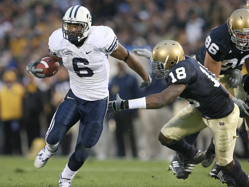 BYU’s Curtis Brown runs by Notre Dame’s Chinedum Ndukwe during game in South Bend, Indiana, Oct. 22, 2005.