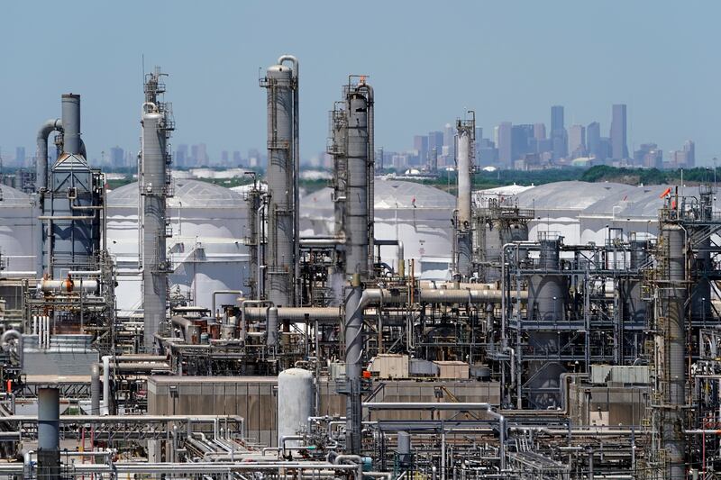 A refinery along the Houston Ship Channel is seen with downtown Houston in the background on April 30, 2020.