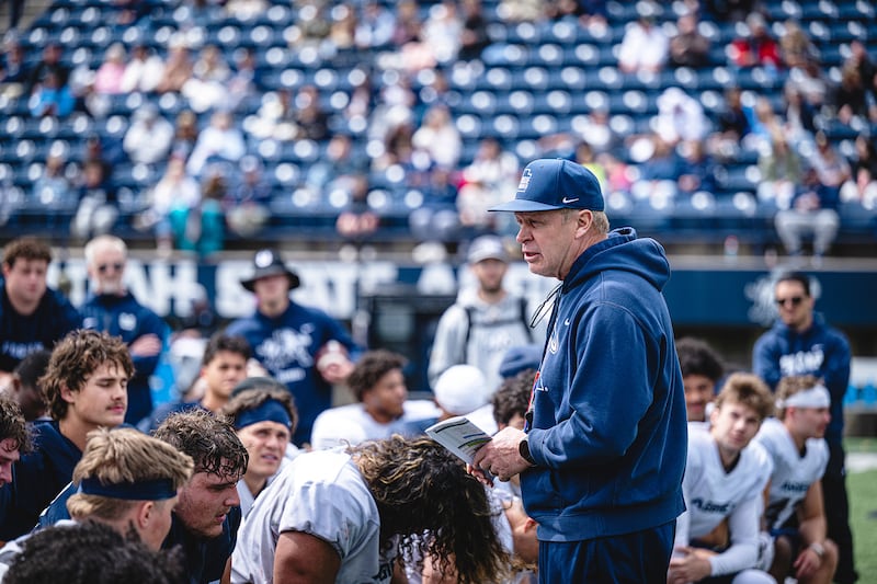 Utah State football coach Bronco Mendenhall talks to his players after a spring camp practice in Logan.