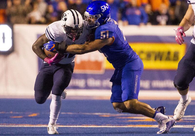 Boise State linebacker Ben Weaver (51) tackles Brigham Young running back Squally Canada (22) during the second half of an NCAA football game between Boise State and Brigham Young in Boise on Thursday, Oct. 20, 2016. Boise State defeated Brigham Young 28-