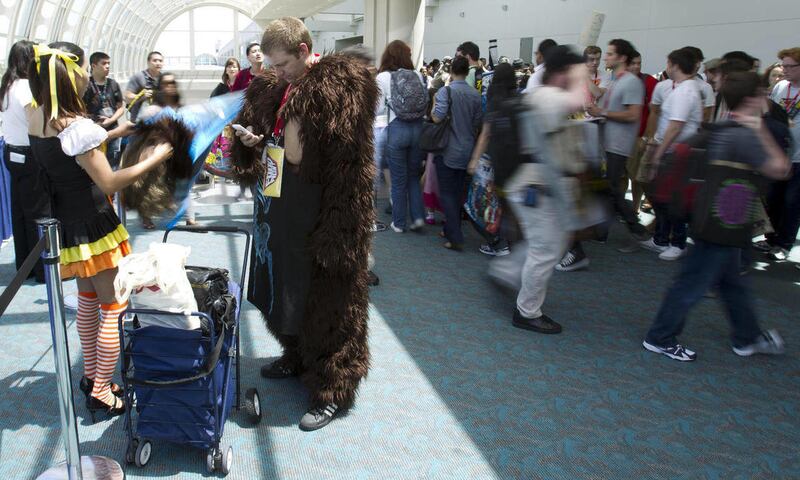 Jed Williston checks his cellphone as he takes a break from being Bigfoot at Comic Con Saturday, July 23, 2011, in San Diego.