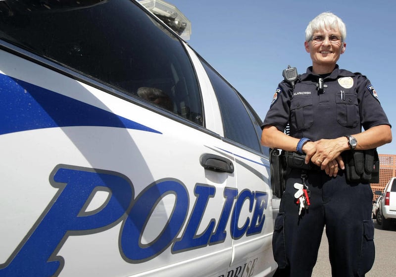 In this Aug. 5, 2011 photo, rookie Officer Wendy Klarkowski poses at the Surprise Police Department in Surprise, Ariz. Klarkowski, 49, was named the department's Rookie of the Year, making her the oldest officer in Surprise to achieve the distinction.