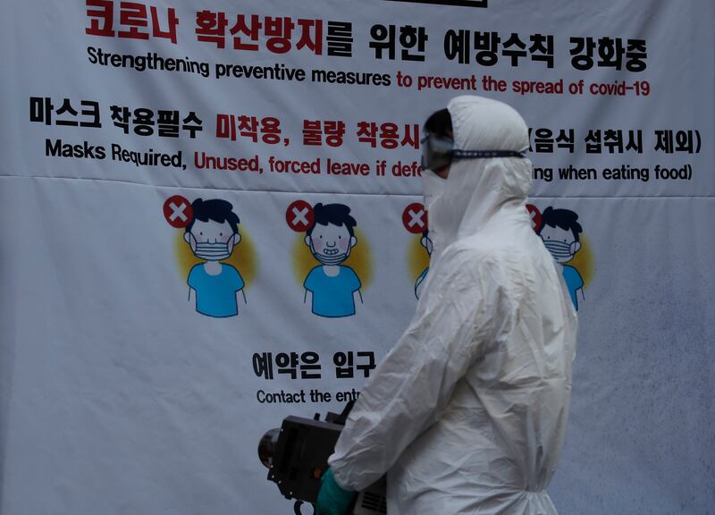 A health official from the district office wearing protective gear disinfects as a precaution against the coronavirus in Seoul, South Korea, Thursday, Oct. 29, 2020.