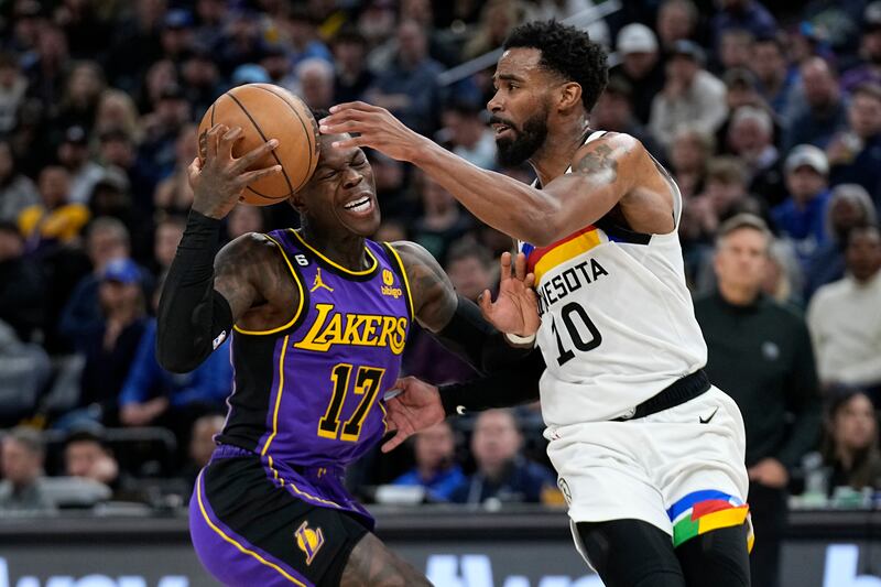 Los Angeles Lakers’ Dennis Schroder works toward the basket while defended by Minnesota guard Mike Conley in Minneapolis.