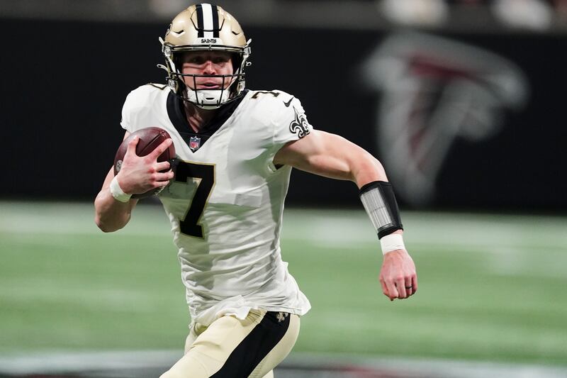 New Orleans Saints quarterback Taysom Hill runs out of the pocket against the Atlanta Falcons Sunday, Jan. 9, 2022, in Atlanta.
