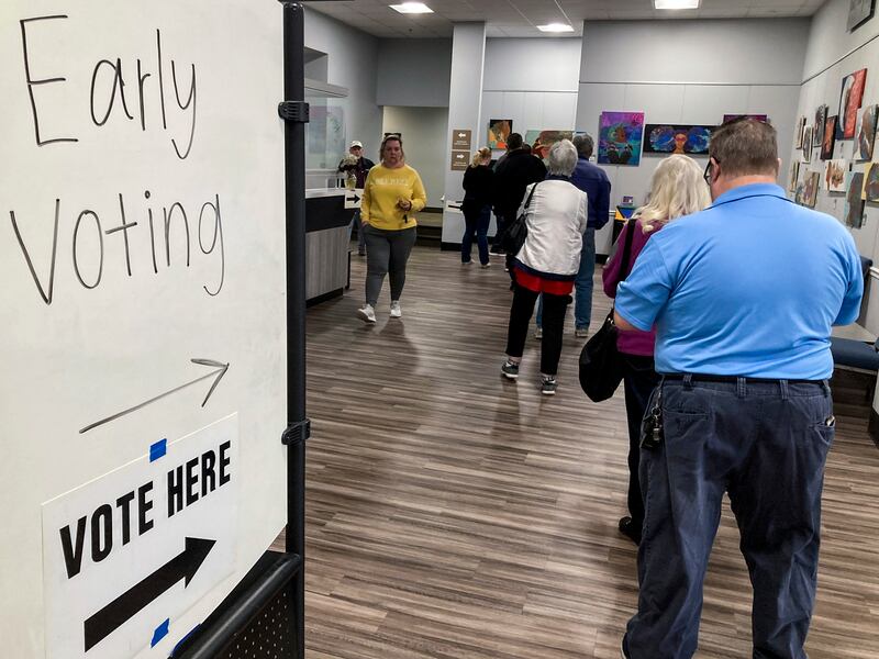 People wait in line near Atlanta to early vote in the Georgia Senate runoff election.