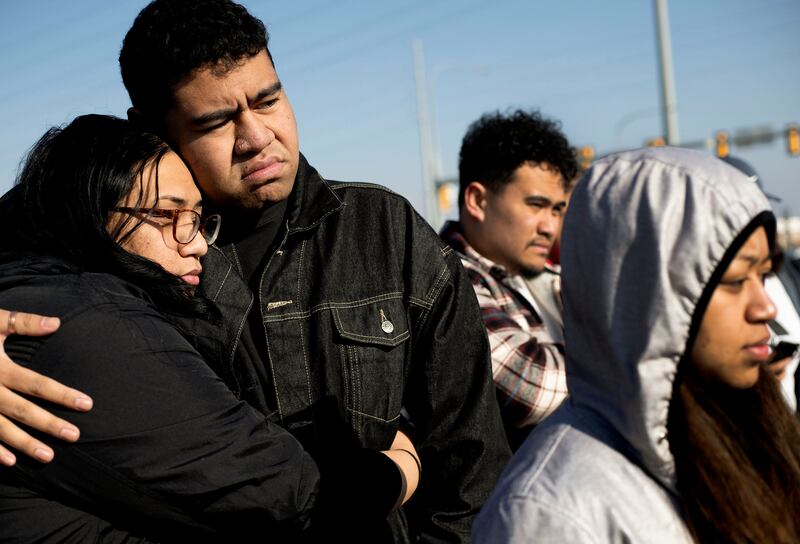 Friends and family members of Paul Tahi and Tivani Lopati at a memorial built in their honor in West Valley on Jan. 14, 2022.