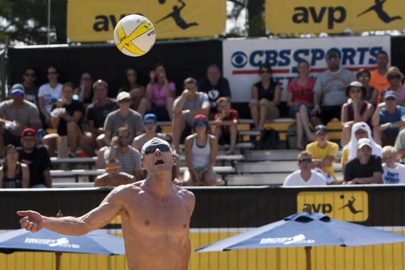 Jake Gibb digs the ball during a Pro Beach Volleyball game at Liberty Park, Friday, Aug. 8, 2014.