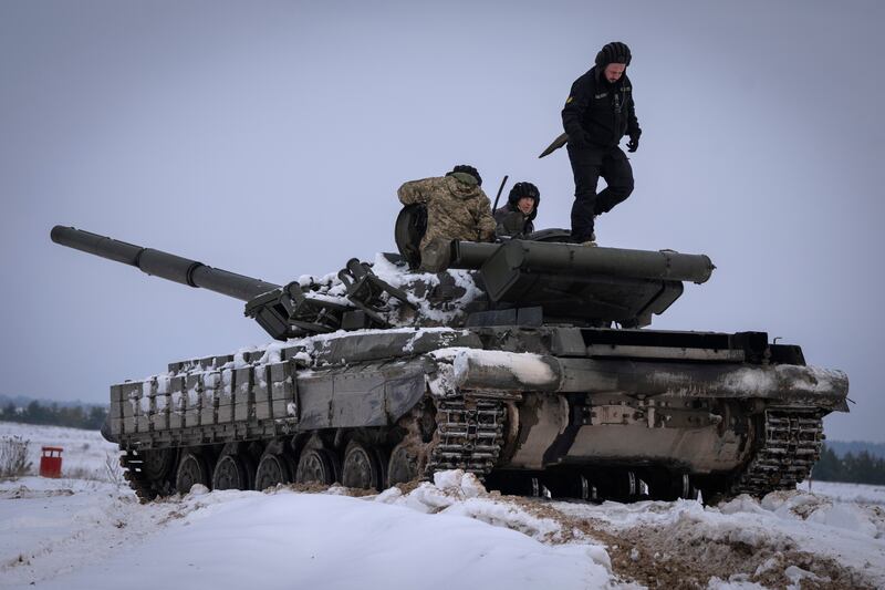 Ukrainian soldiers practice on a tank during military training in Ukraine.