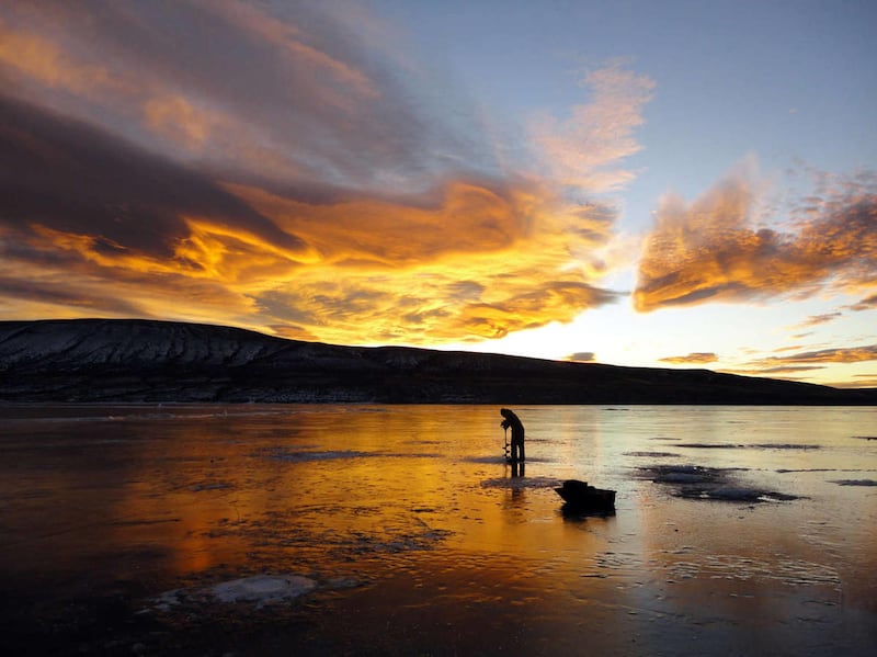 This undated photo provided by the Utah Division of Wildlife Resources shows an angler fishing for burbot at Flaming Gorge, Utah.