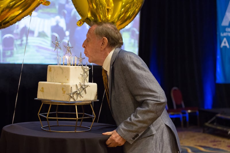 Richard Bushman blows out candles on a birthday cake at a dinner on Saturday, Sept. 25, 2021.