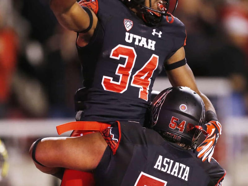 Utah Utes running back Bubba Poole (34) celebrates his touchdown against Oregon during Pac12 action in Salt Lake City Saturday, Nov. 8, 2014.