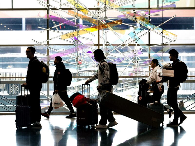 People walk through Salt Lake City International Airport. A record number of travelers passed through the airport in 2023.