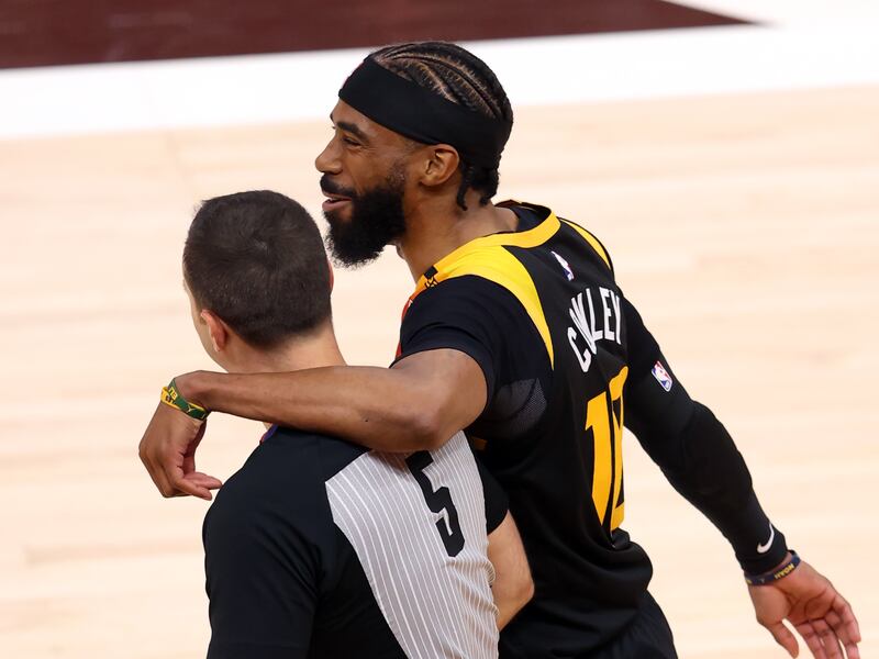 Utah Jazz guard Mike Conley (10) puts his arm around referee Kane Fitzgerald (5) as they walk back up court as the Utah Jazz and Memphis Grizzlies play Game 2 of their NBA playoffs first round series at Vivint Arena in Salt Lake City on Wednesday, May 26, 2021.