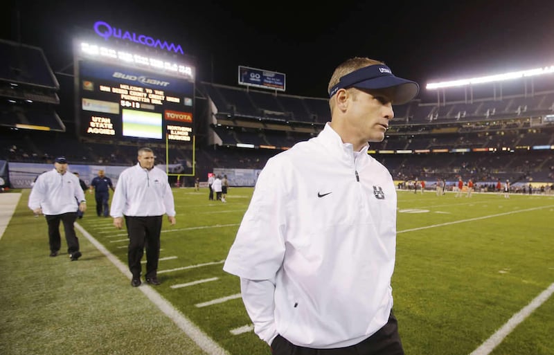 Utah State Aggies head coach Matt Wells walks the sidelines during warmups for the Poinsettia Bowl in San Diego Thursday, Dec. 26, 2013.