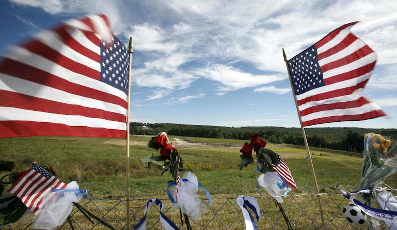 FILE - In this Sept. 11, 2010 file photo, flags frame the crash site of United Flight 93 at the temporary Flight 93 memorial in Shanksville, Pa. Family members on Wednesday, March 9, 2011 will ask Congress to approve the $3.7 million for the memorial Obam