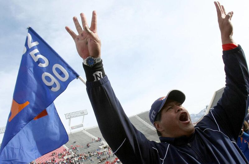 Former Timpview head coach Louis Wong holds up 4 fingers after his team won it's 4th straight 4A championship November 20, 2009 in Salt Lake City, Utah after Timpview beat Springville. Big changes are coming in the way high school athletes are allowed to