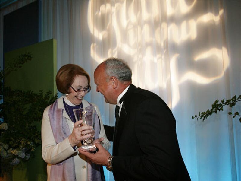Bishop Carolyn Tanner Irish talks with Chamber President Lane Beattie as he shows her the award before program.