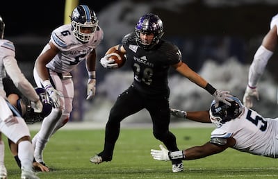 Weber State Wildcats running back Josh Davis (28) looks for running room as Weber State and Maine play in FCS quarterfinal football action in Ogden on Friday, Dec. 7, 2018. Maine won 23-18.