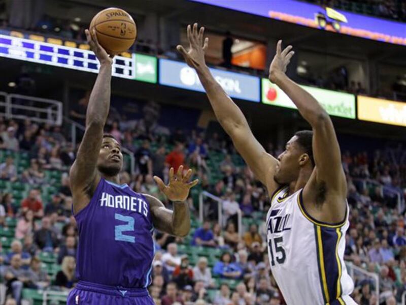 Charlotte Hornets forward Marvin Williams (2) shoots as Utah Jazz forward Derrick Favors (15) defends in the first quarter in an NBA basketball game Monday, March 16, 2015, in Salt Lake City. (AP Photo/Rick Bowmer)