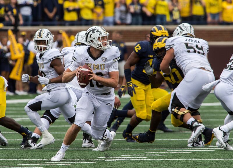 Western Michigan quarterback Jon Wassink (16) rolls out looking to throw a pass in the third quarter of an NCAA college football game against Michigan in Ann Arbor, Mich., Saturday, Sept. 8, 2018. Michigan won 49-3. (AP Photo/Tony Ding)