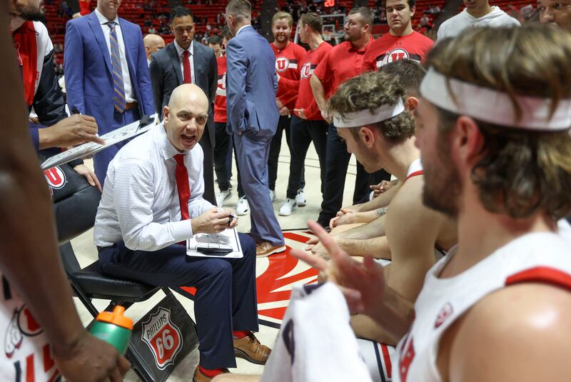 Utah Utes head coach Craig Smith talks in a huddle to his team