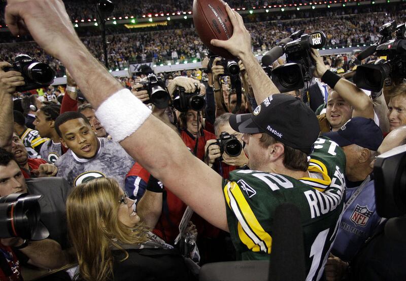 Aaron Rodgers, right, holds the Vince Lombardi Trophy alongside teammate Clay Matthews.