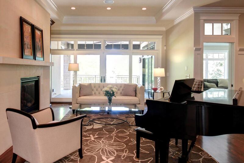 These French doors and windows, visible from the home's entry, provide lots of natural light to the space and also offer an inviting view of a covered deck and beautiful back yard.